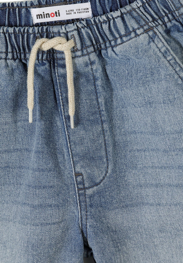 Detail of blue denim shorts with elasticated waistband and drawstring.