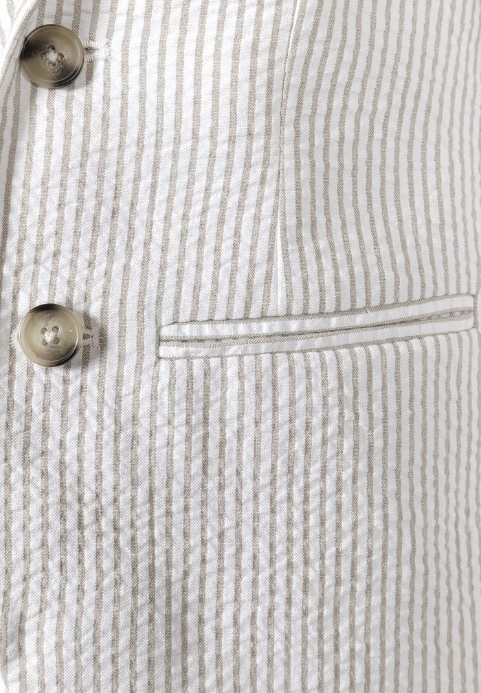 Detail of a boys' stone striped blazer with front button and side pocket.