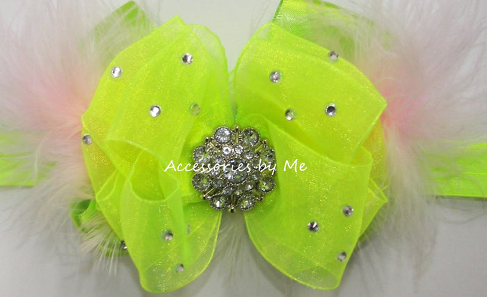 Neon green hair bow with rhinestones, layered with pink marabao feathers on a white background