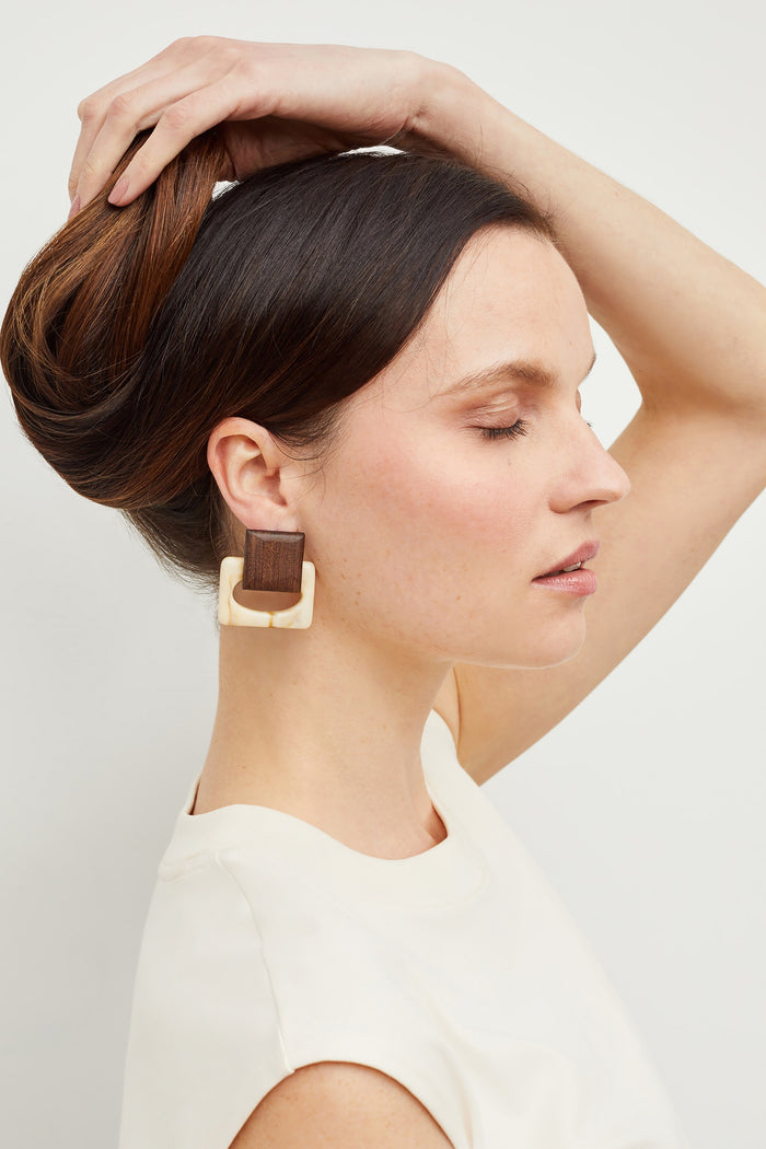 Front image of a woman standing wearing the Mardy Earrings in Brown / Ivory | Grid Hover | Exclude