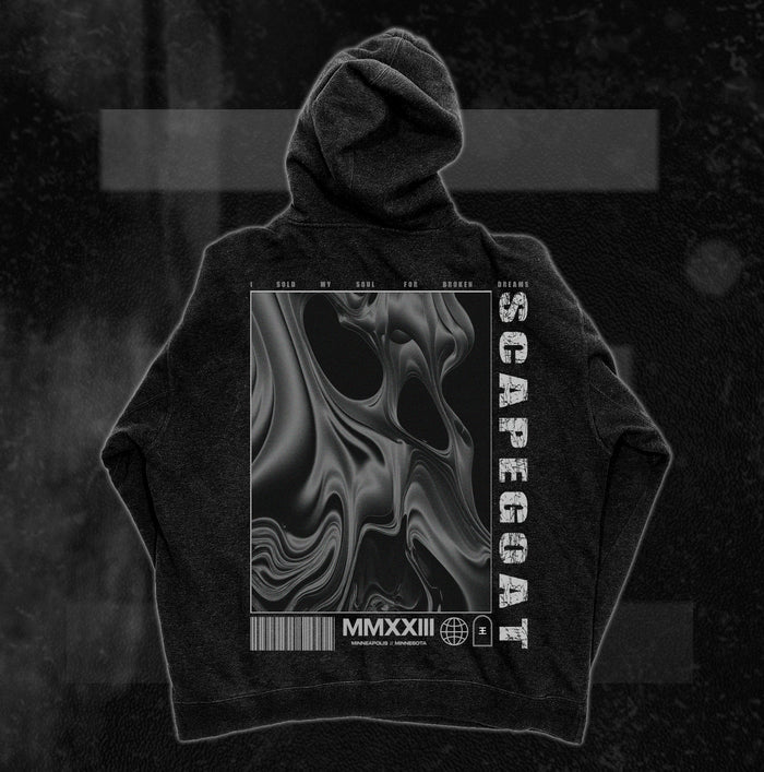 A black Reflections pullover hoodie made from soft ring-spun cotton, featuring an abstract swirling face graphic with “SCAPEGOAT,” “SOLD MY SOUL FOR BROKEN DREAMS,” MMXXIII, symbols, and a barcode as bold finishing touches.