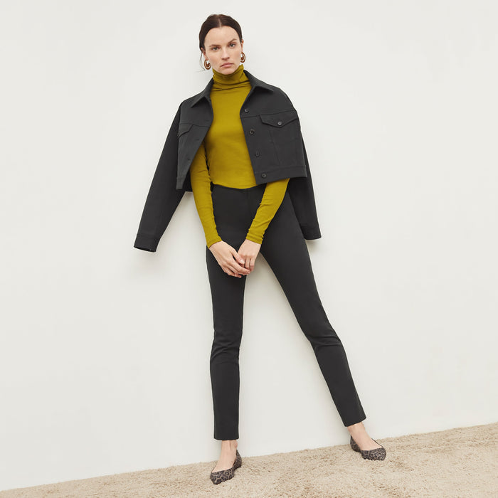 Front image of a woman standing wearing the anna jacket in hemlock