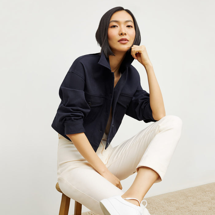 Side image of a woman standing wearing the Anna Jacket—Better Than Denim in Ink
