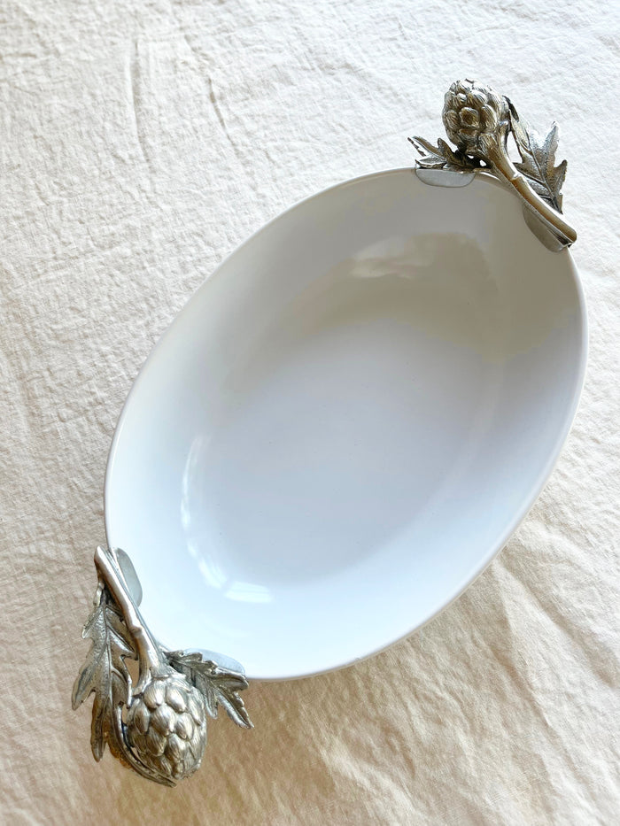 serving dish white with pewter artichoke handles on linen tablecloth