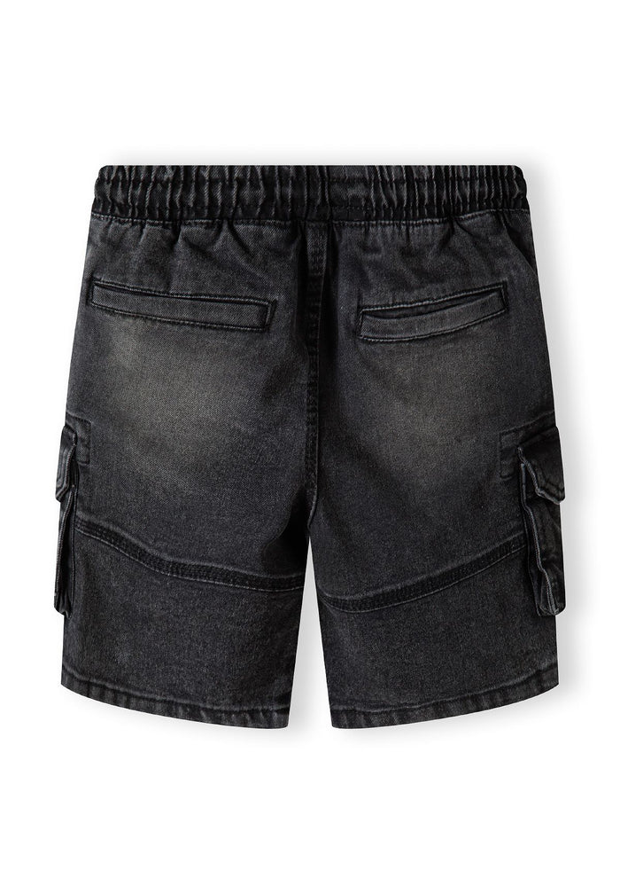 Back view of black denim cargo shorts with elastic waistband and large side pockets.