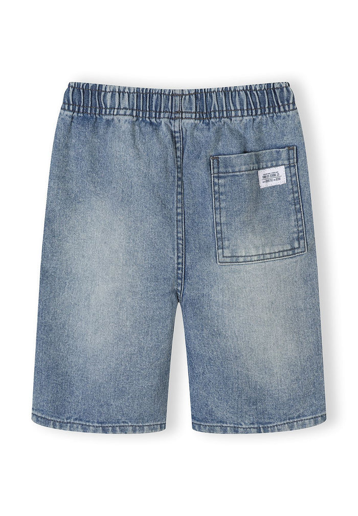 Detail of blue denim shorts with elasticated waistband and back pocket.