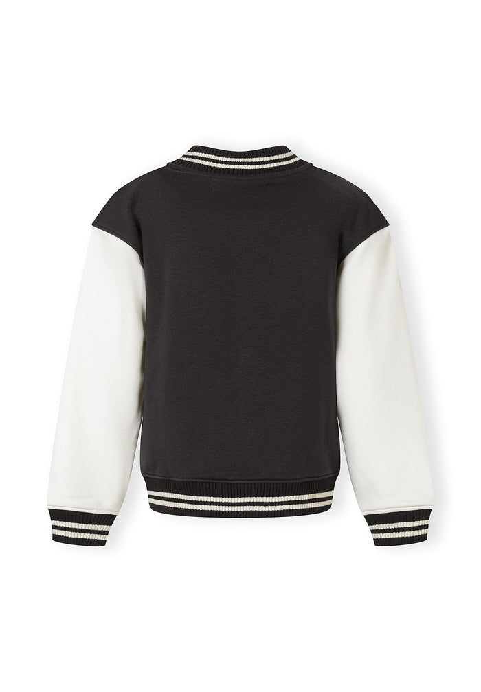 Back view of a boys' lightweight baseball jacket with black and white contrast sleeves.
