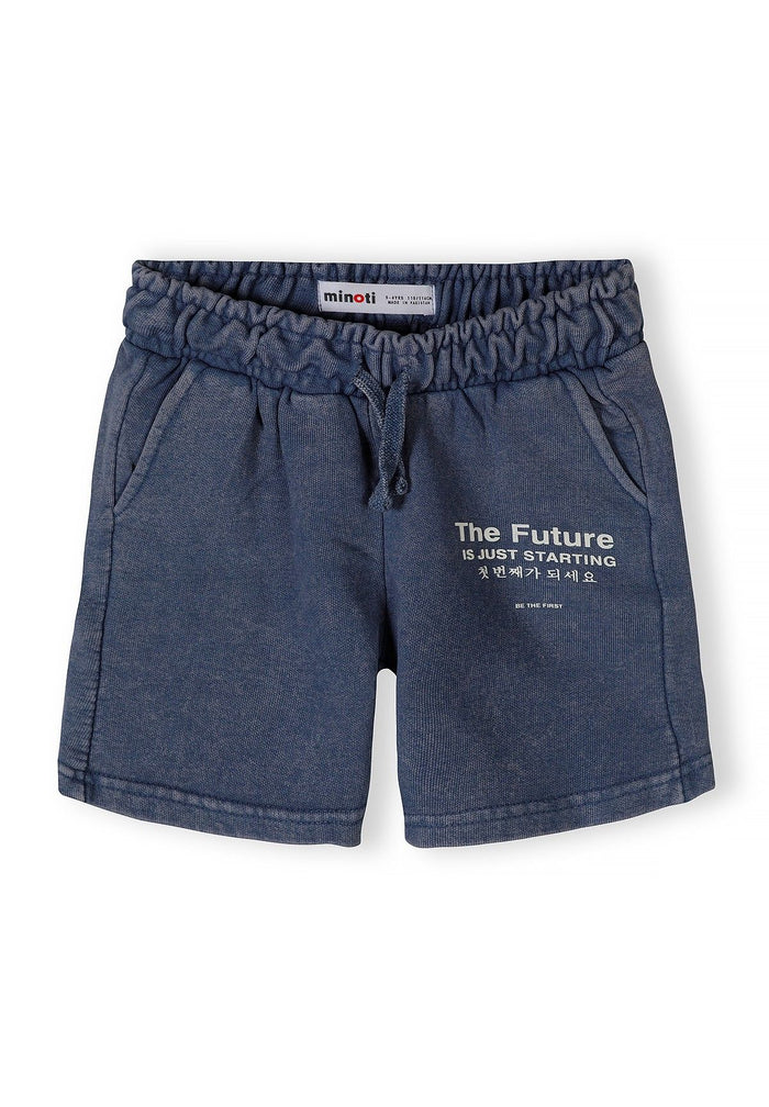 Detail of boys' blue acid wash shorts with elastic waistband and side pockets.