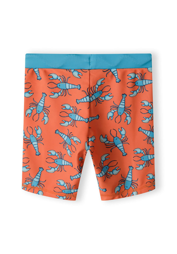 Boys swim shorts in bright orange with blue lobster print, back view.