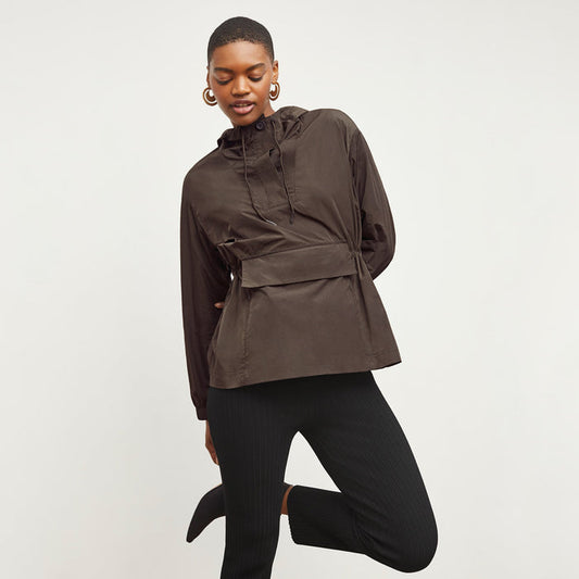 Front image of a woman standing wearing the Britt Hoodie—AirTech in Dark Moss | Lead