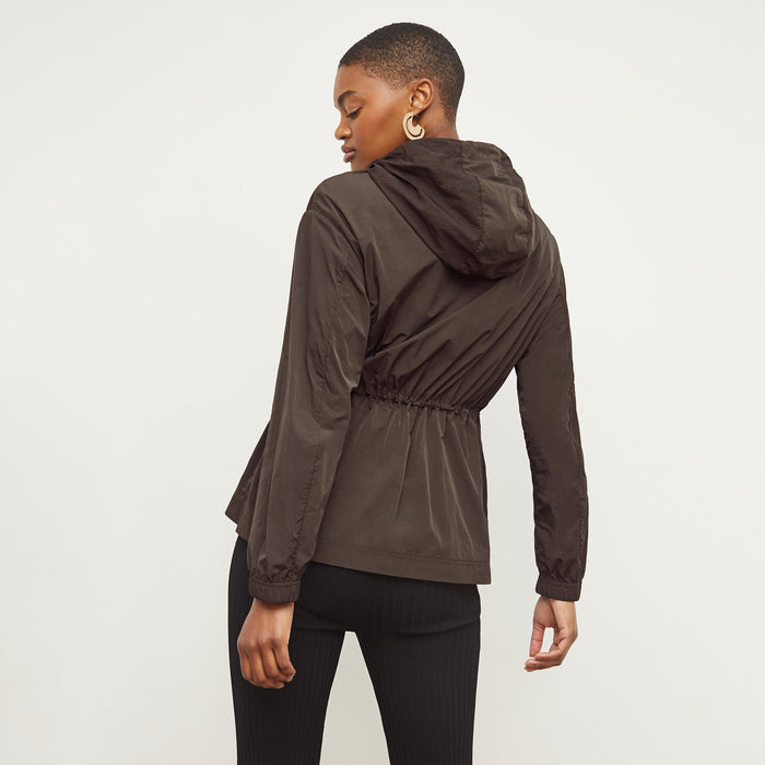 Back image of a woman standing wearing the Britt Hoodie—AirTech in Dark Moss