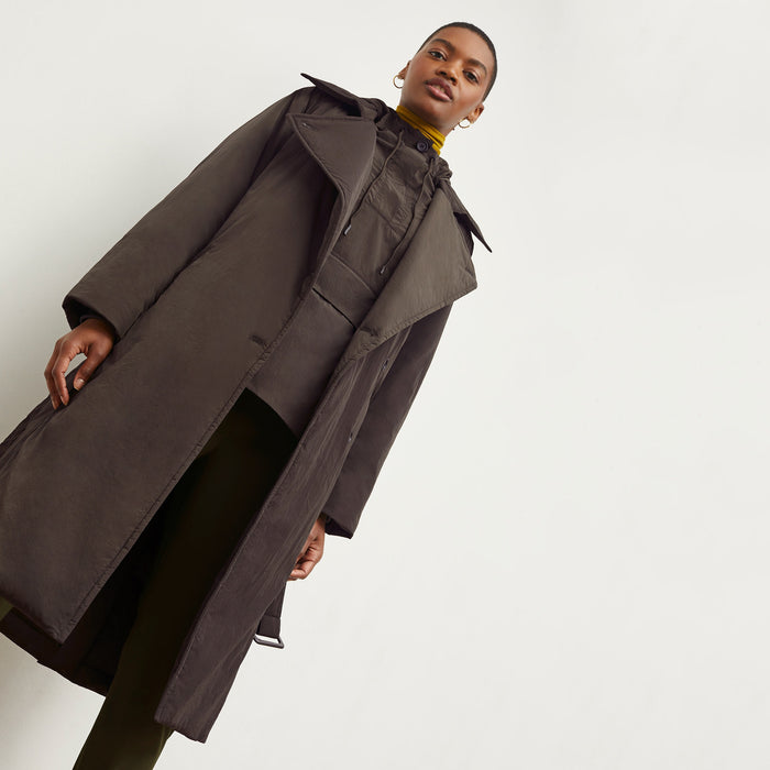 Front image of a woman standing wearing the Britt Hoodie—AirTech in Dark Moss