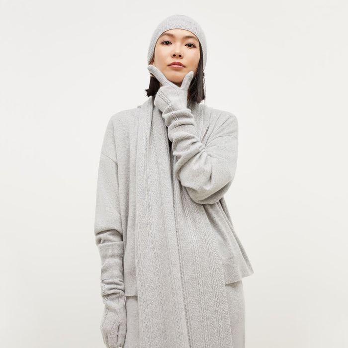 Front image of a woman standing wearing the Circle Cable Gloves—Cashmere in Heather Gray
