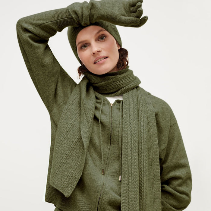 Front image of a woman standing wearing the Circle Cable Scarf—Cashmere in Olive | Exclude
