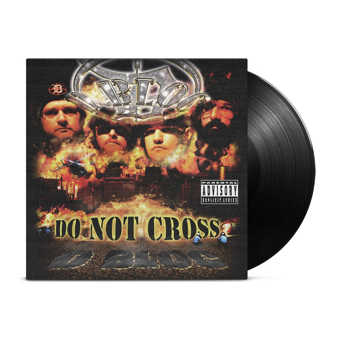 The image shows a D Bloc vinyl record partially out of its sleeve. The cover displays four faces above a fiery cityscape with helicopters, explosions, DO NOT CROSS tape, and a parental advisory label, suggesting a theme of chaos and order.