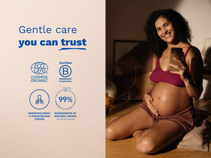 Pregnant woman holding a phone with product certification logos on the left.