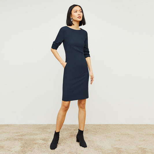 Front image of a woman standing wearing the Etsuko Dress—Recycled WonderTex in Midnight | Lead