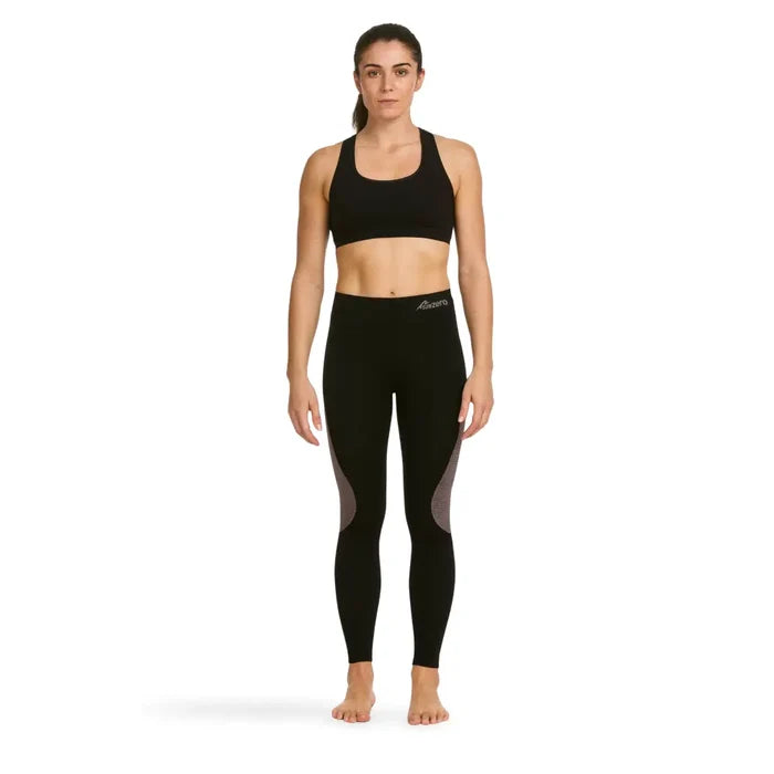 Woman wearing black athletic sports top and Sub Zero Factor 1 Plus stretch base layer leggings in black and pink on a white background