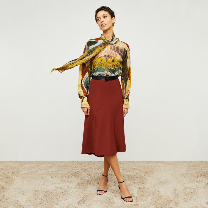 Front image of a woman standing wearing the Fiona Top—Silk Desert in Multicolor