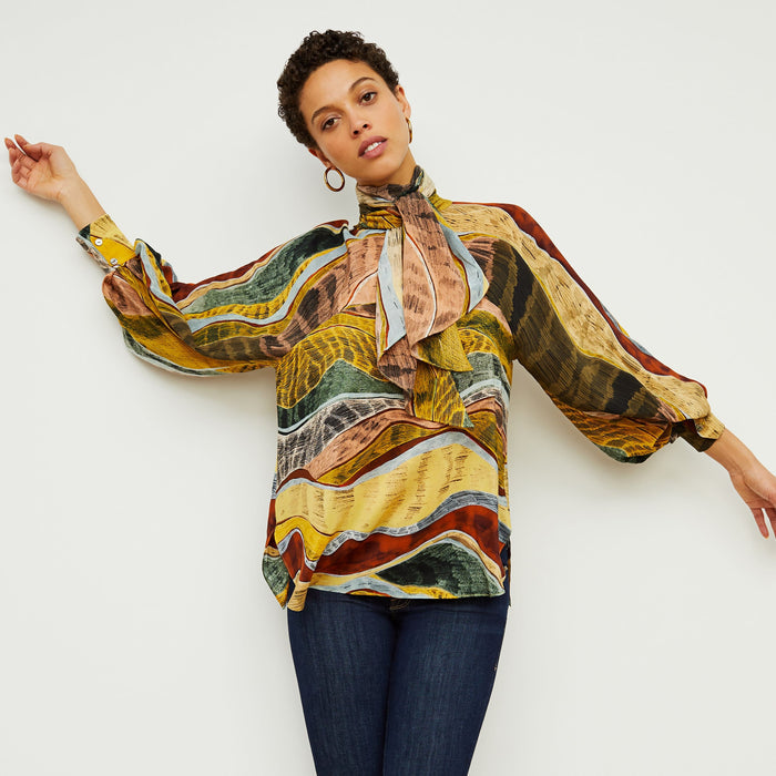 Front image of a woman standing wearing the Fiona Top—Silk Desert in Multicolor