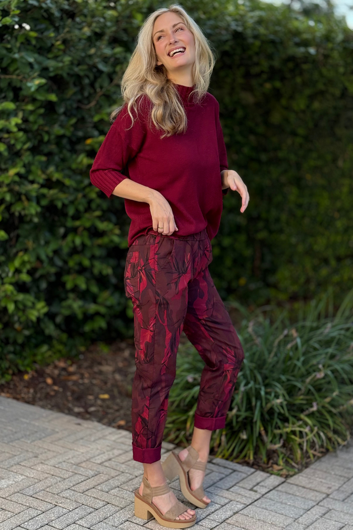 Front view of model wearing Flora Ashley Pull-On Printed Pants in burgundy floral print