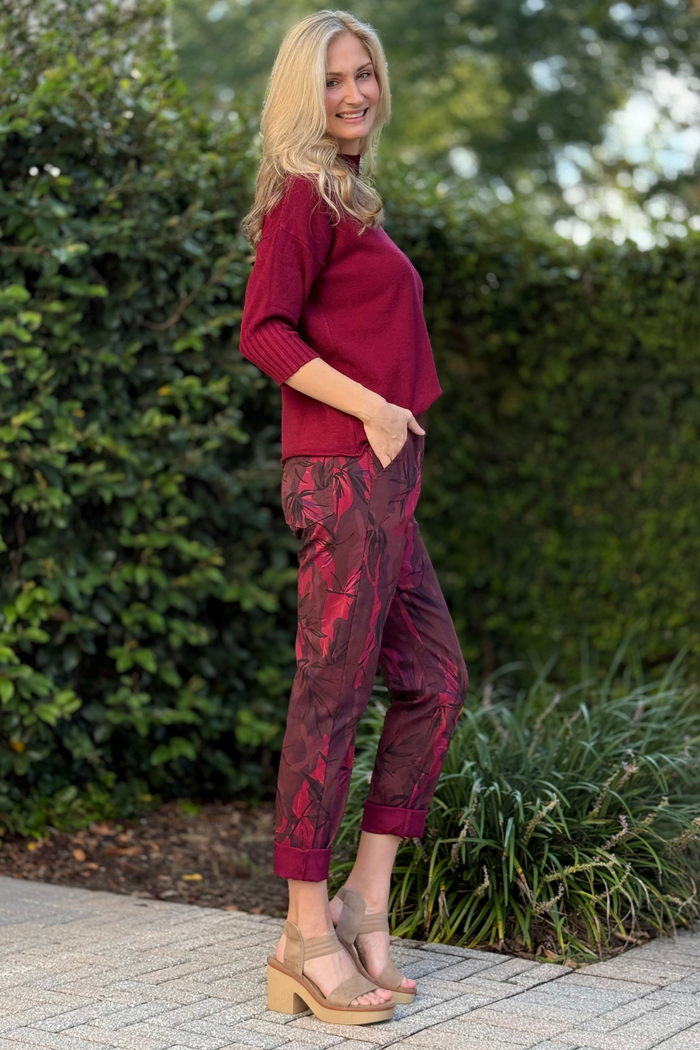 Side angle of Flora Ashley burgundy printed pants showing relaxed fit