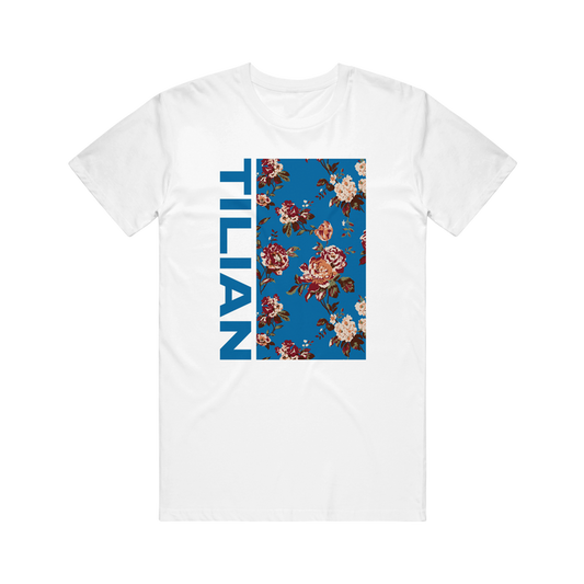 Tilian white T-shirt with a vertical blue rectangle, floral pattern, and bold blue TILIAN lettering down the left side of the rectangle.