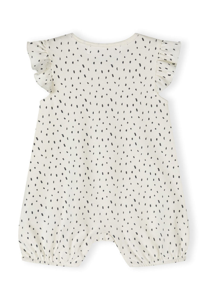 Back view of cream girls romper with frill sleeves and black dot pattern.