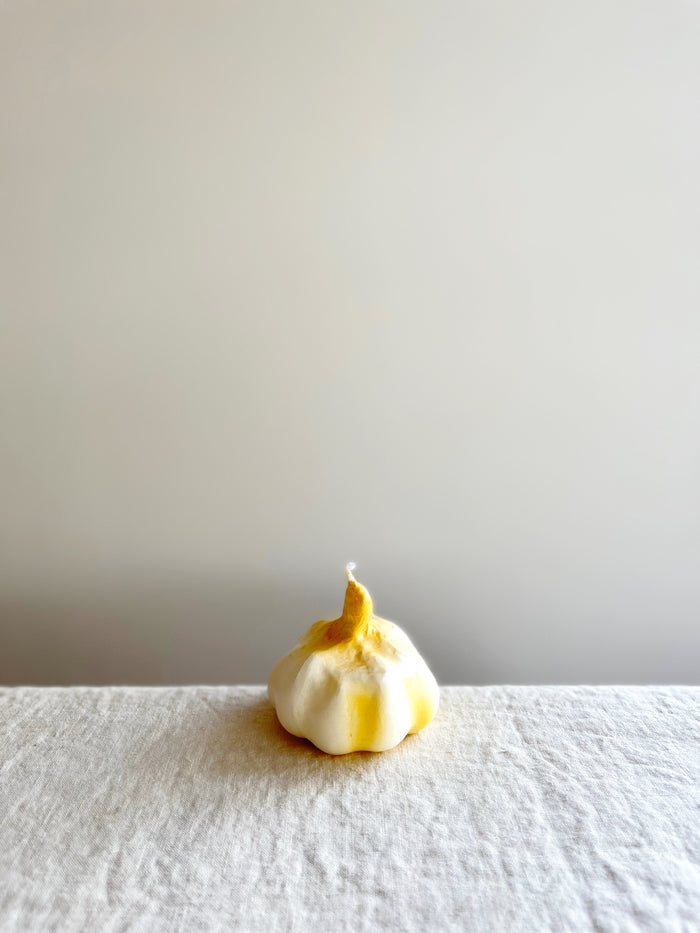 cereria introna garlic shaped paraffin candle on white table