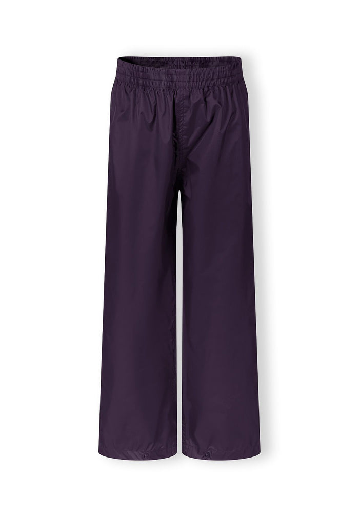 Packaway waterproof overpants in solid purple, front view, featuring elasticated waist and ankle cuffs.