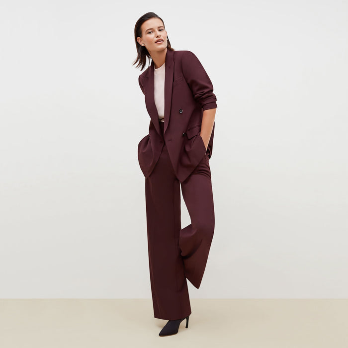 Front image of a woman standing wearing the Hadley Pant-Sharkskin in garnet