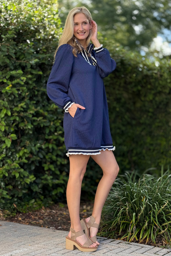 Close-up of half zip neckline and contrast stripe details