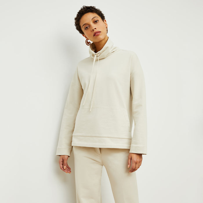 Front image of a woman standing wearing the Harris Sweatshirt—Fine Terry in Pearl | Lead