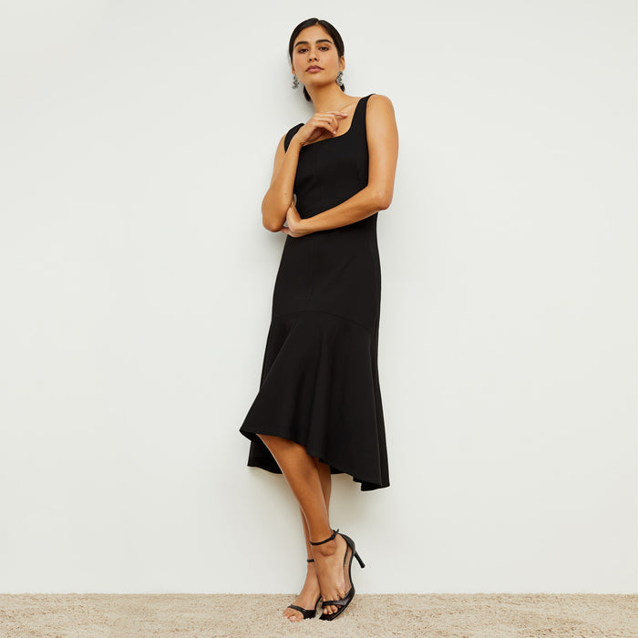 Front image of a woman standing wearing the james dress in black