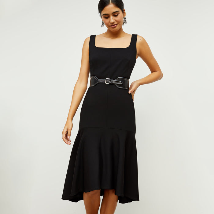 Front image of a woman standing wearing the james dress in black