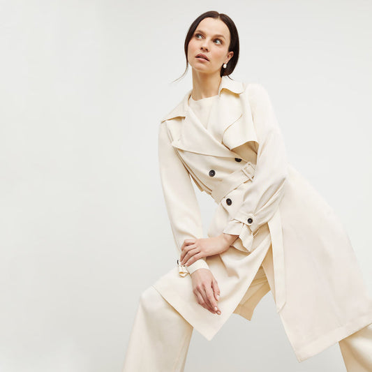 Front image of a woman standing wearing the Jensen Trench—SustainSilk in Pearl | Lead