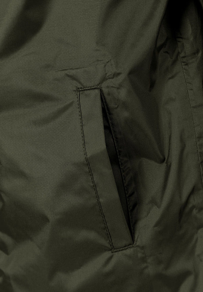 Detail of a khaki kids waterproof jacket showing a side pocket.