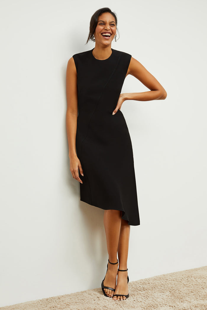 Front image of a woman standing wearing the Lara Dress in Black | Grid | Exclude
