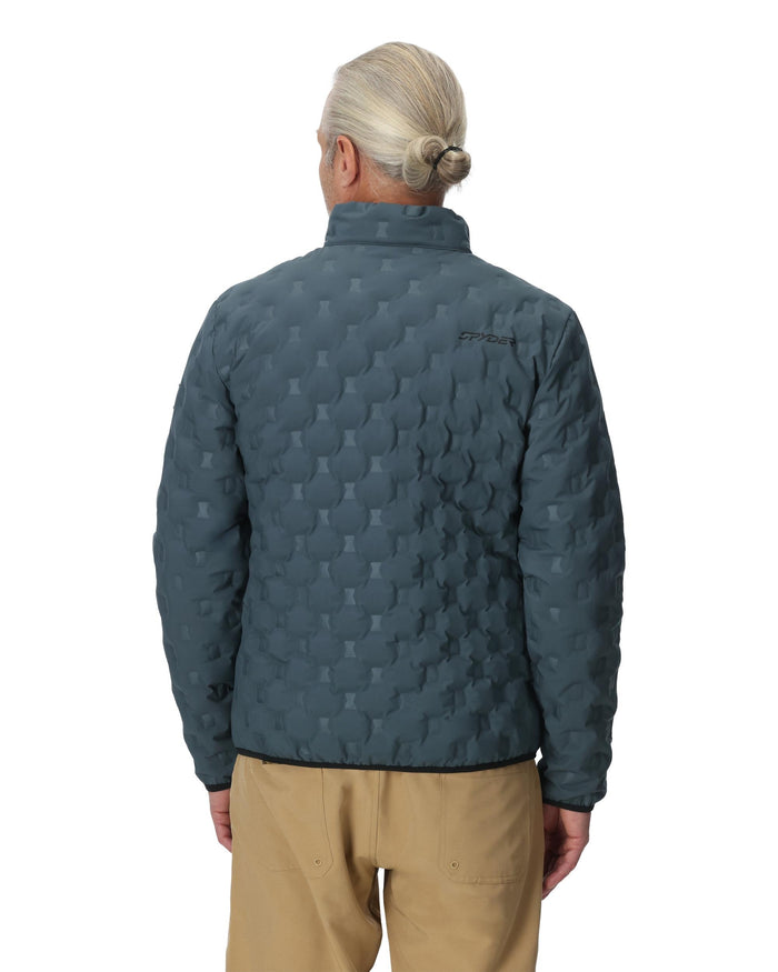 Person wearing a textured blue jacket on a white background