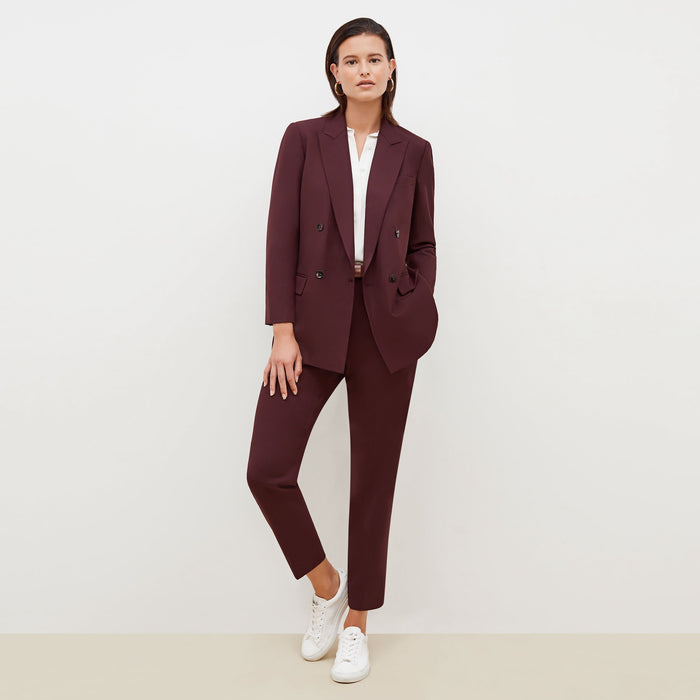 Front image of a woman standing wearing the O'Hara Blazer-Sharkskin in garnet
