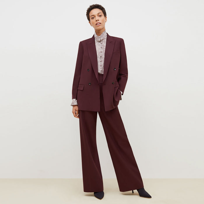 Front image of a woman standing wearing the O'Hara Blazer-Sharkskin in garnet