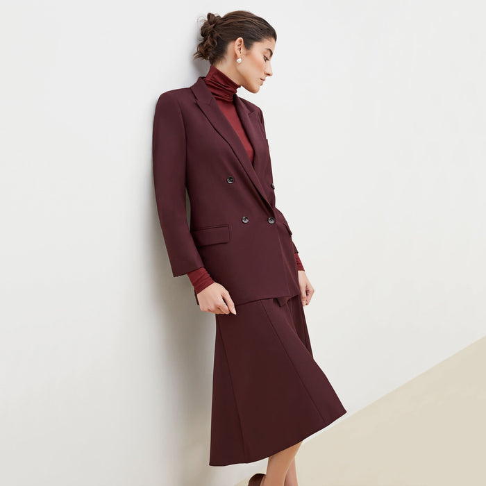 Side image of a woman standing wearing the O'Hara Blazer-Sharkskin in garnet