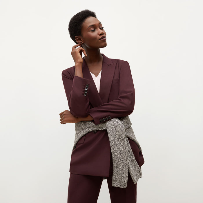Front image of a woman standing wearing the O'Hara Blazer-Sharkskin in garnet