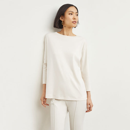 Front image of a woman standing wearing the Owen T-Shirt—Pima Cotton in Ivory | Lead
