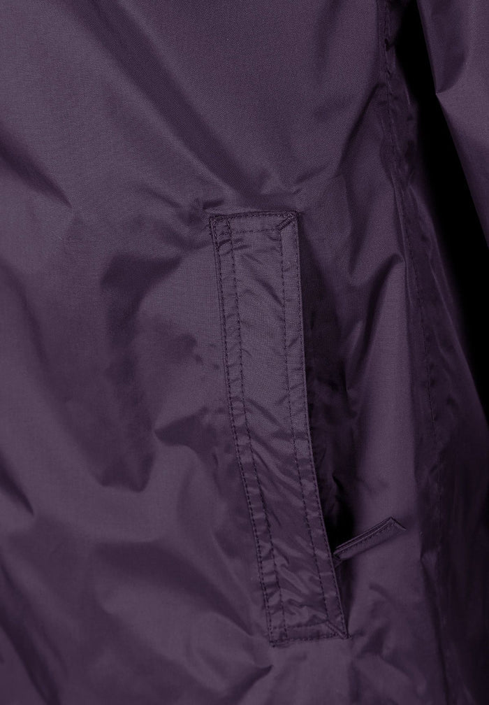 Detail of a purple women's waterproof jacket showing a zipped pocket.