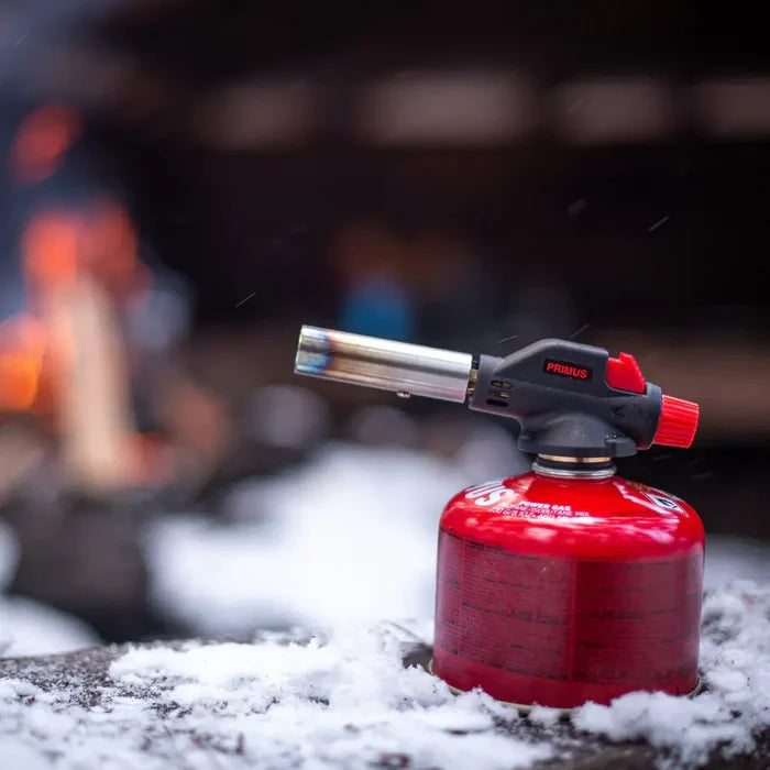Primus Fire Starter on a snowy surface with a blurred background