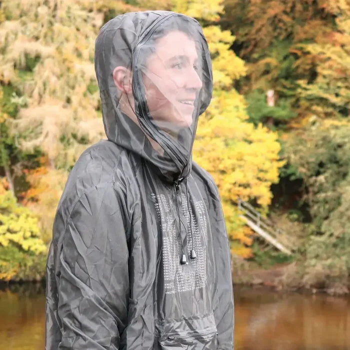 Lifestyle image of a Pyramid midge jacket being worn by a woman outdoors by a river shown from the front