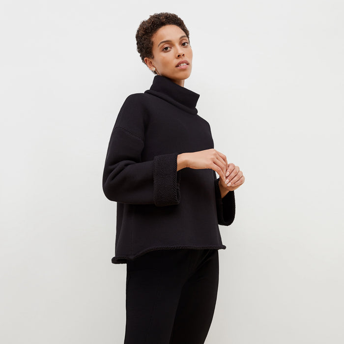 Side image of a woman standing wearing the Sharon Top—Plush Terry in Black