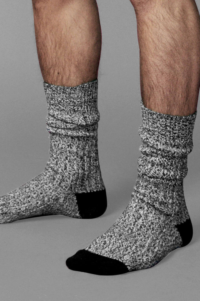 Close up of a man wearing the Tech Boot Sock in Coal Marl