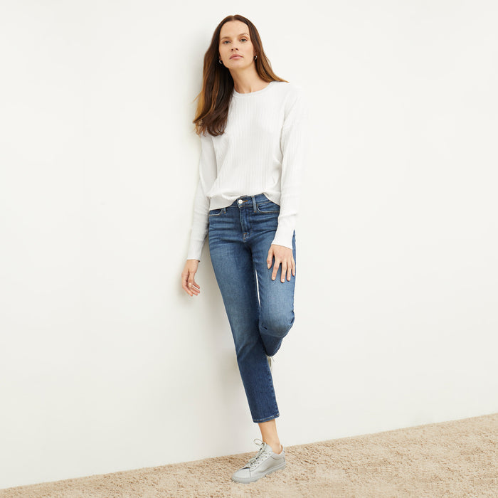Front image of a woman standing wearing the tyler sweatshirt in ivory